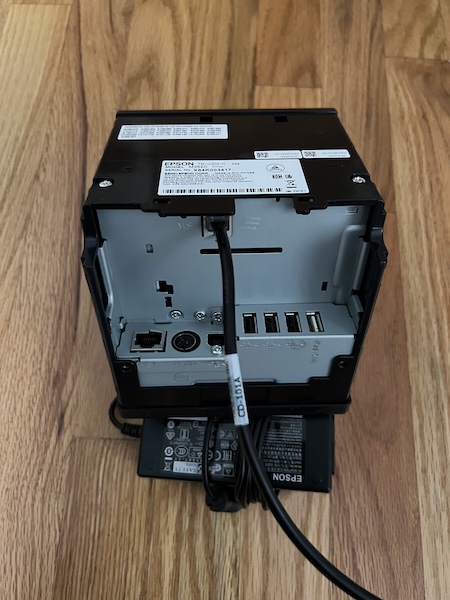 An Epson TM Series printer with an ethernet cable attached