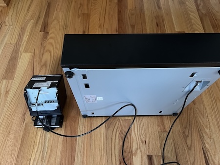 An Epson TM Series printer connected to a cash register.