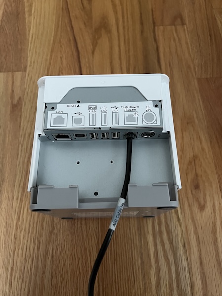 A Star Micronics mc-Print3 printer with a cable connected to the Cash Drawer slot.