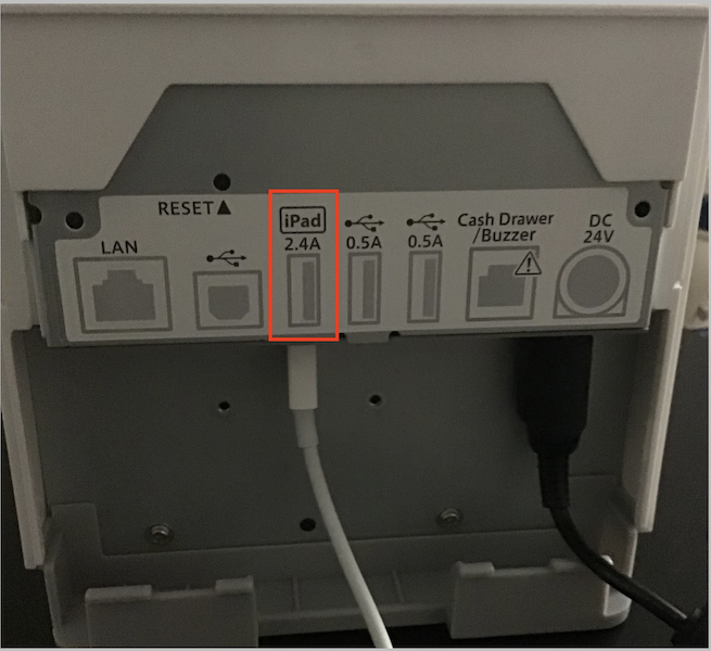 A USB cable connection between an iOS device and a printer